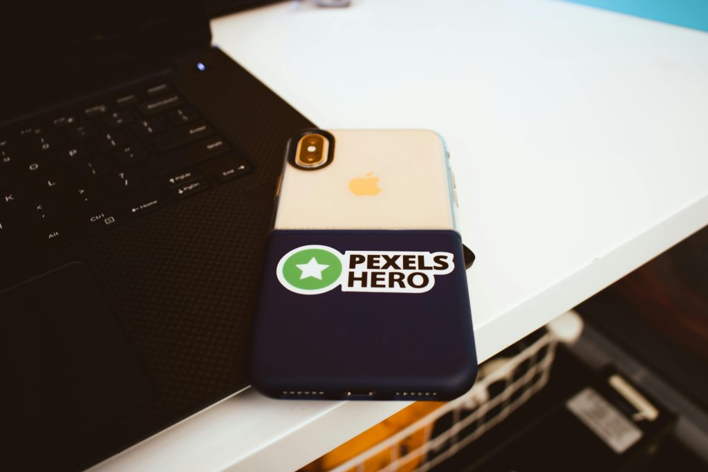 Close-up of a laptop and smartphone on a desk, showcasing modern technology setup.